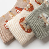 Close-up of boys baby socks with embroidered designs and soft knit texture
